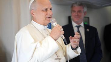 Pope Leo XIV (L) speaks to journalists aboard the papal flight from Malabo, Equatorial Guinea to Rome, Italy, 23 April 2026, at the end of his 11-day apostolic journey to Africa.