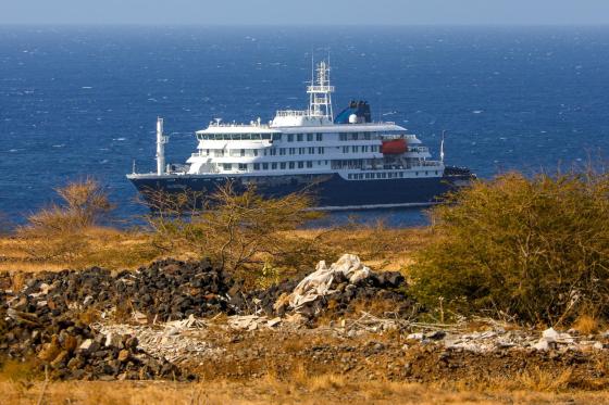 Dutch cruise ship MV Hondius (back) is anchored off the coast of the city of Praia on the island of Santiago, Cape Verde, 04 May 2026, after three people died onboard from an acute respiratory syndrome. 